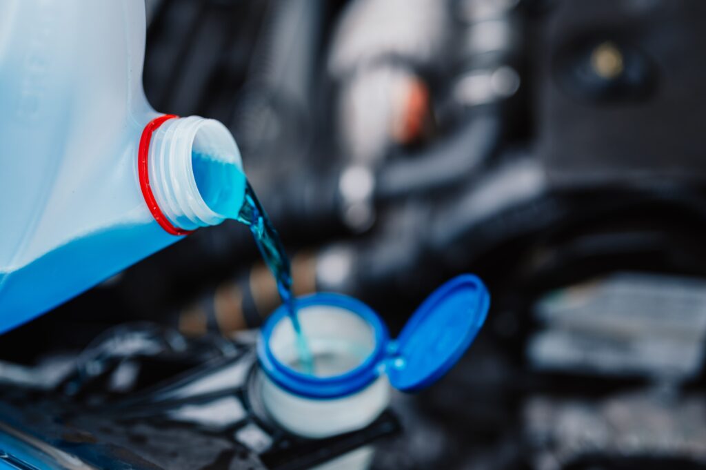 pouring-antifreeze-filling-windshield-washer-tank-with-antifreeze-winter-cold-weather-1-min